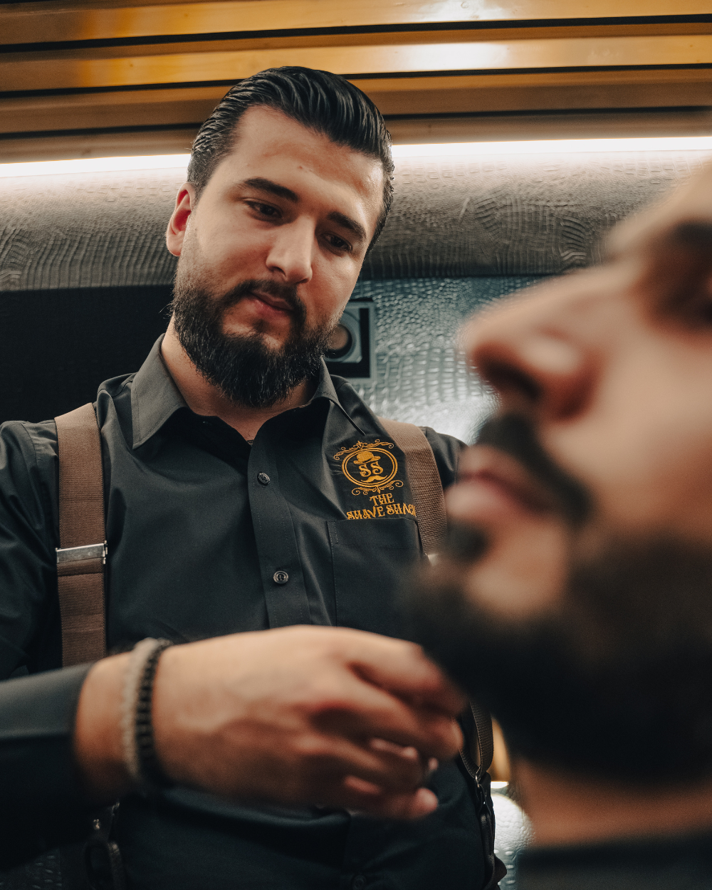Barber trimming a beard